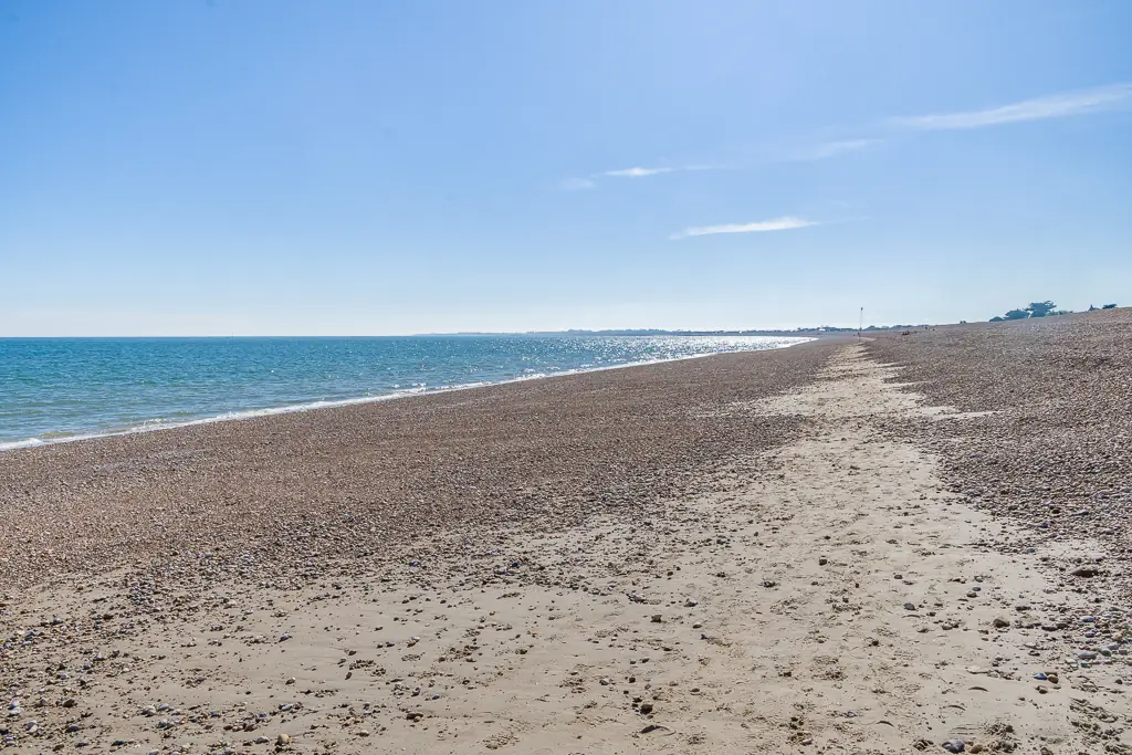 Quiet shingle and sand beach at Aldwick on a clear day