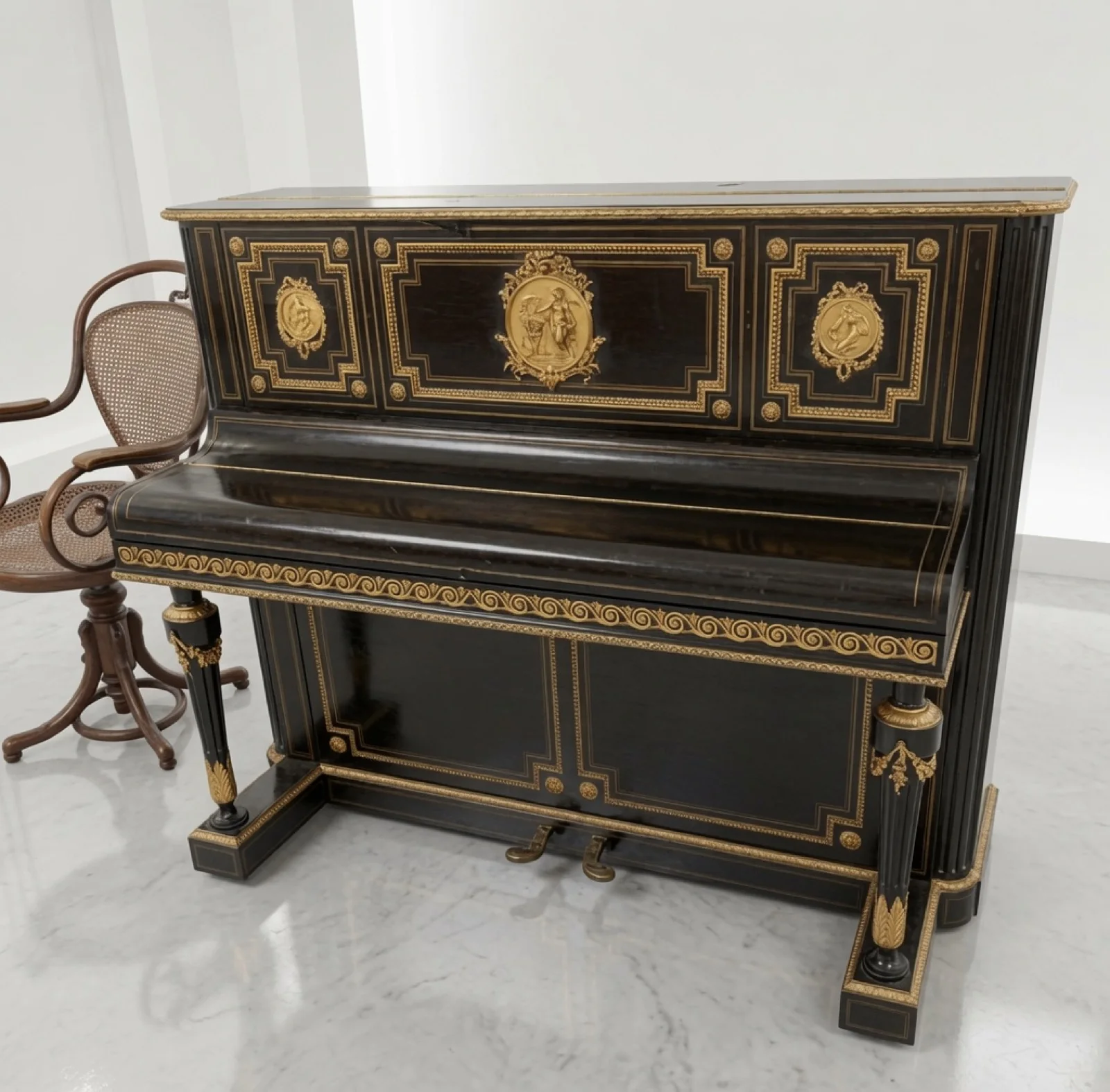 An antique ebonised upright piano with gilt ormolu medallions