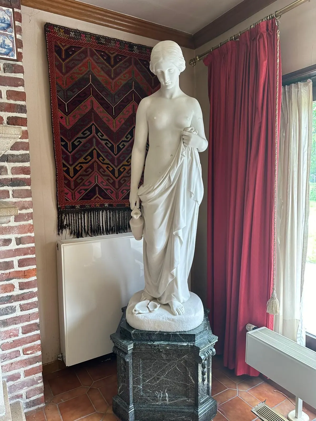 An antique marble draped statue prepared for transport to Europe