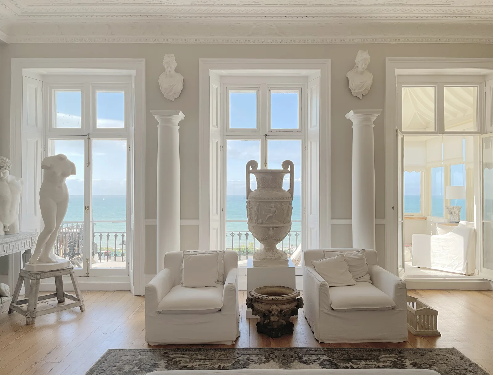 Grand room of antiques and statues with a sea view during a move in Guildford, Surrey