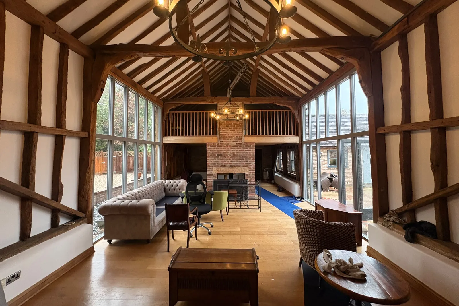Oak-beamed barn near Haywards Heath, with blue floor protection laid for the move to Horsham