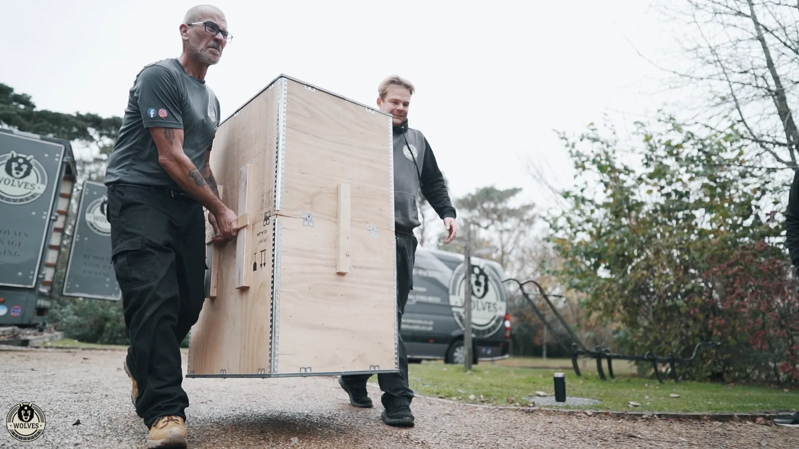A Wolves Removals crew carrying an export crate to the van for an international shipment