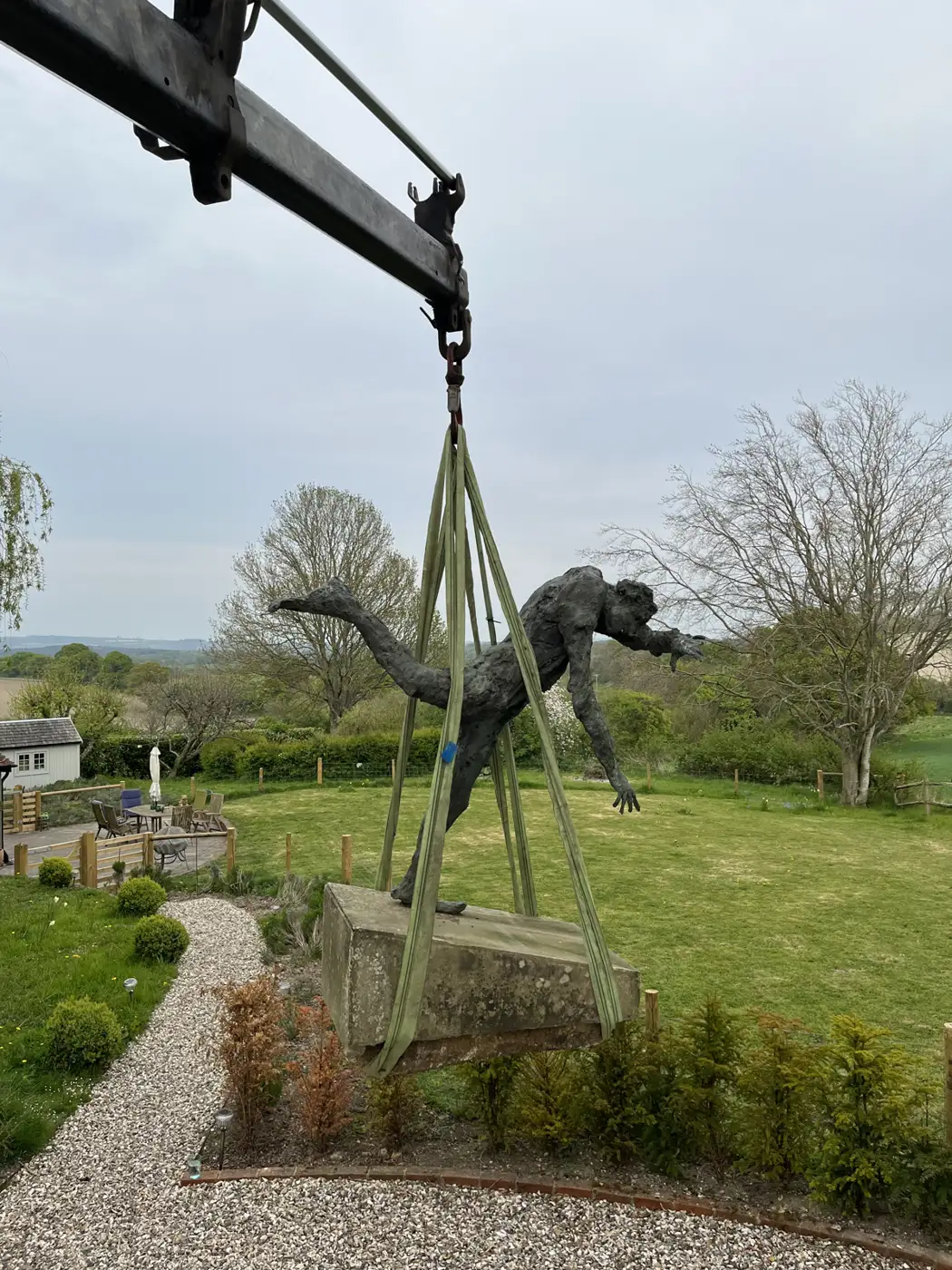 HIAB crane lifting a large garden statue — a Polegate removal