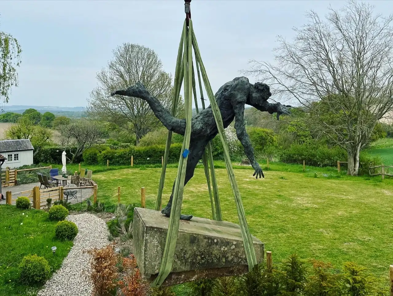 Craning a bronze statue in a garden in Eastbourne, East Sussex