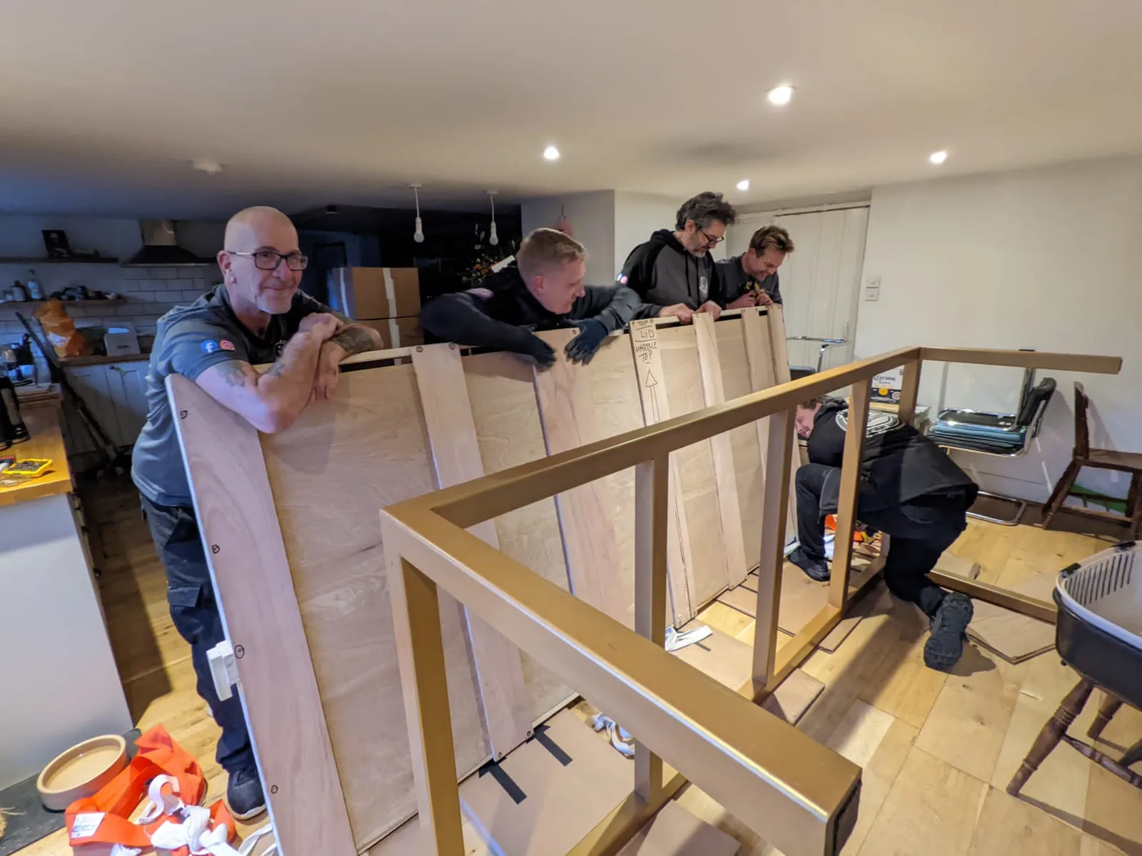 Crew handling a large framed mirror in a room
