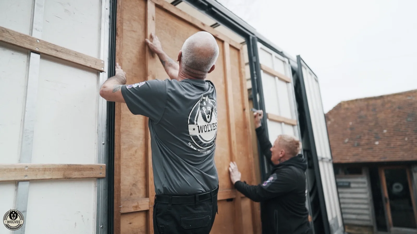 Crew member loading a crate into a van in Redhill