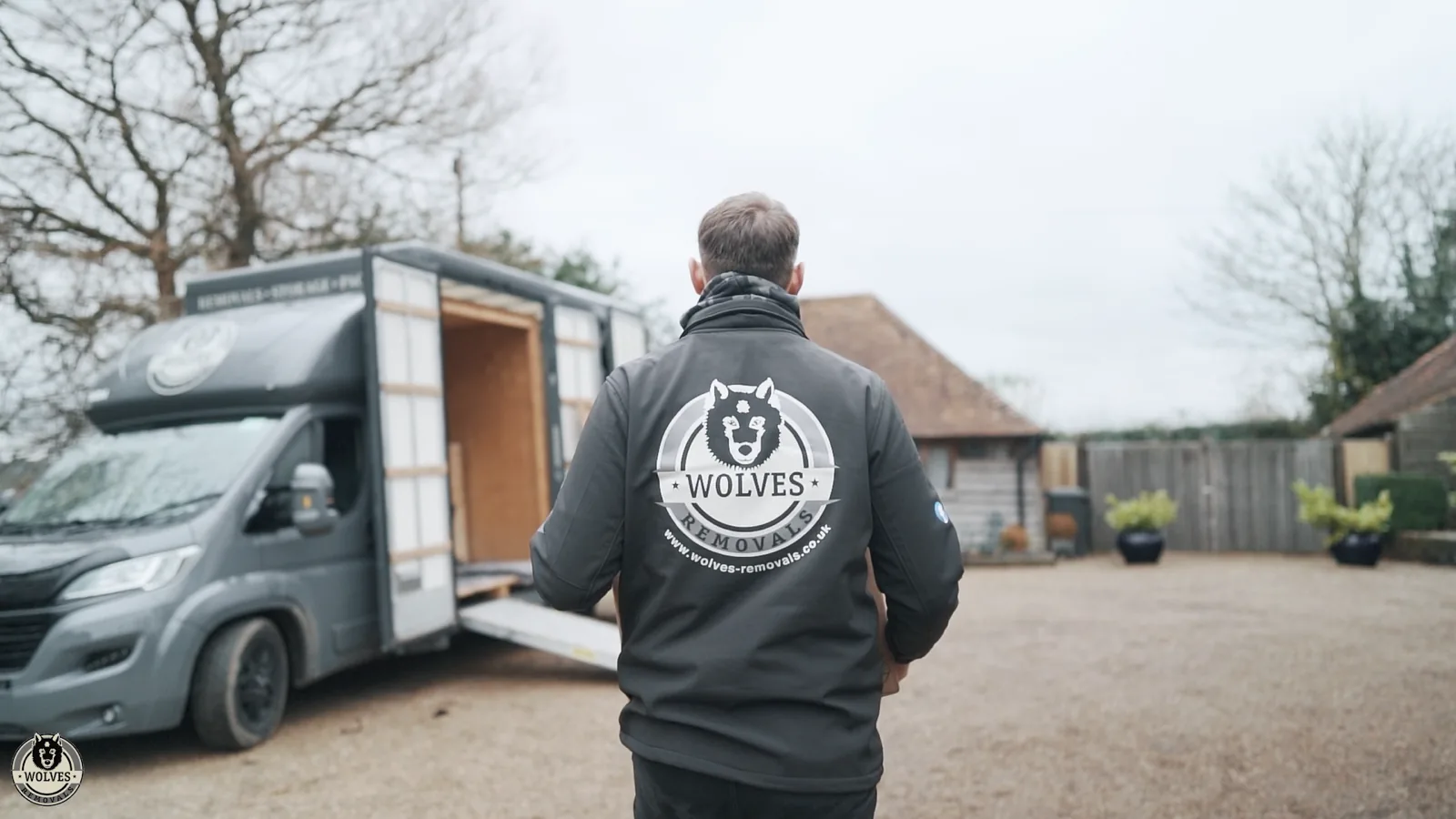 A mover walking to the van by a barn in Kent