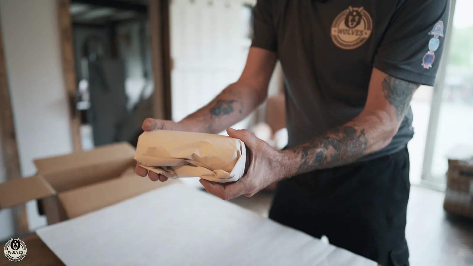 A Wolves Removals packer carefully placing a small fragile item into a cushioned box