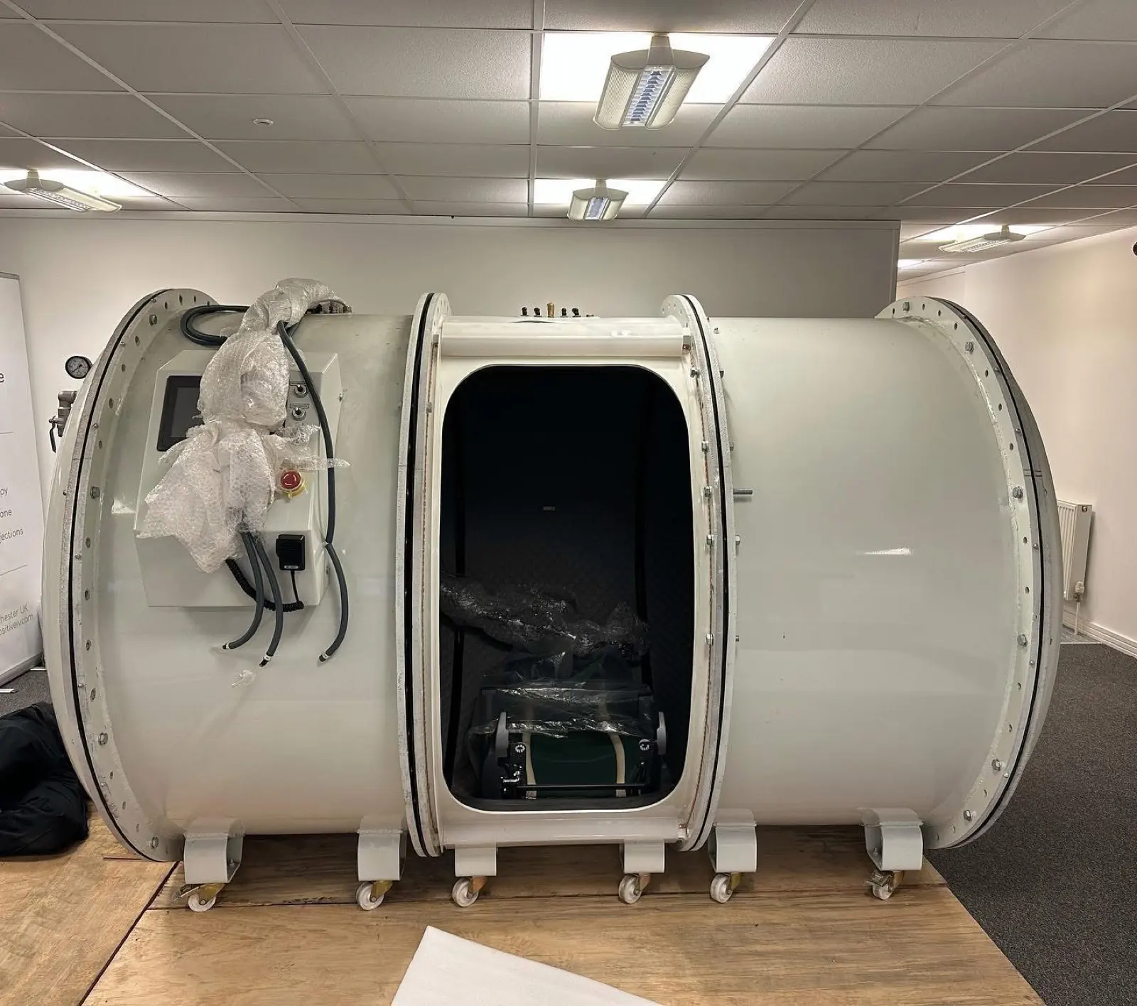 Wolves Removals moving a wrapped specialist pressure chamber out of an office