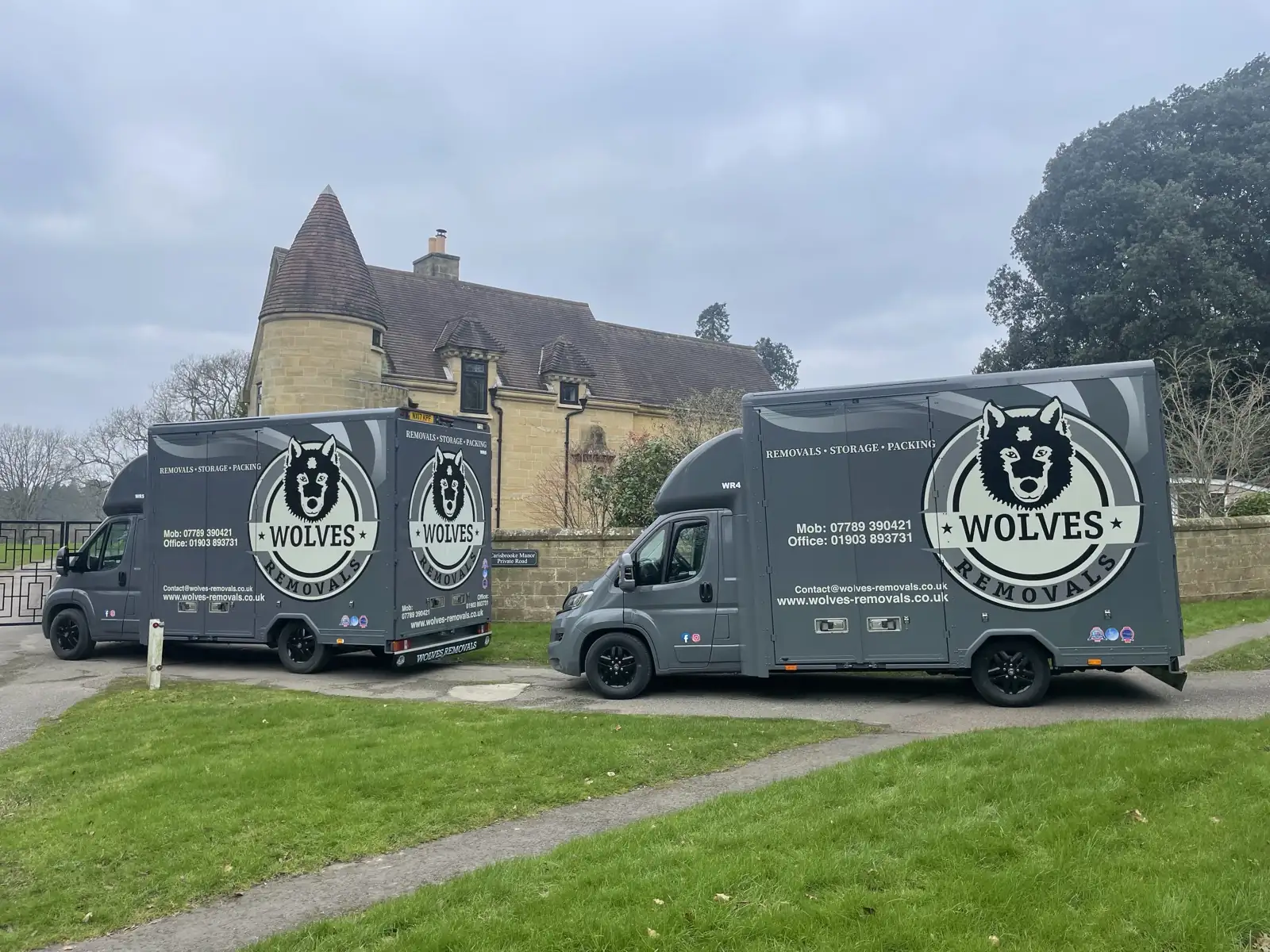 Two removal vans at country house