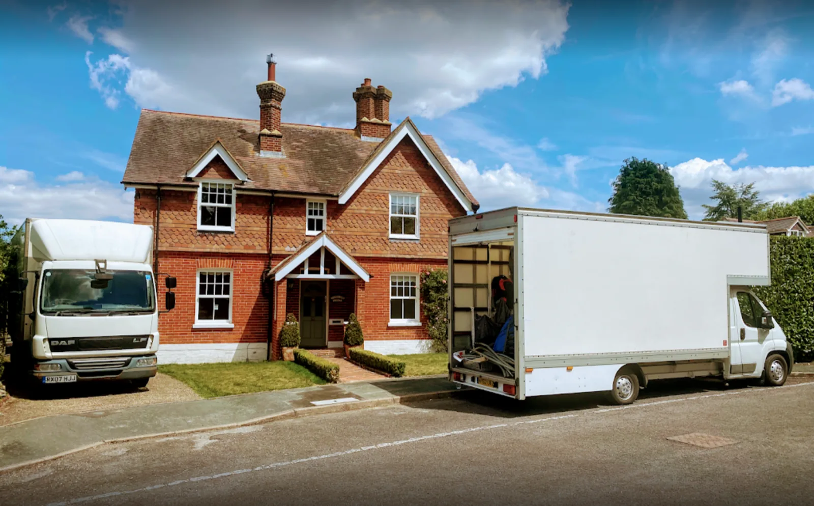 Two vans outside red brick house