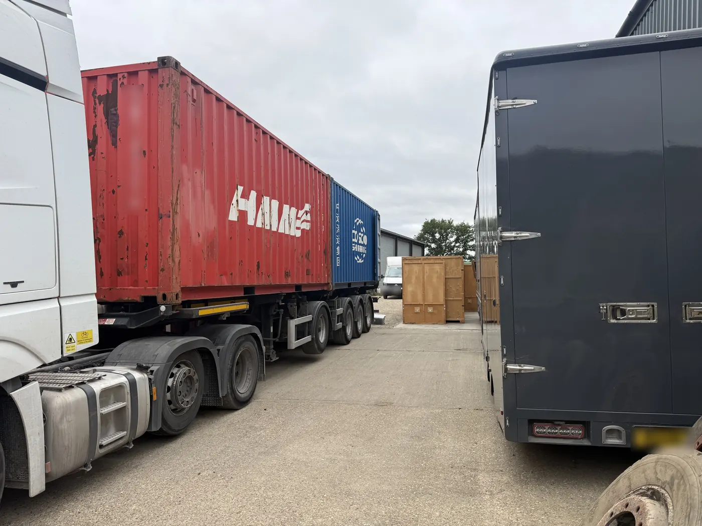 Shipping container off the boat at Southampton arriving by trailer at the Wolves Removals yard