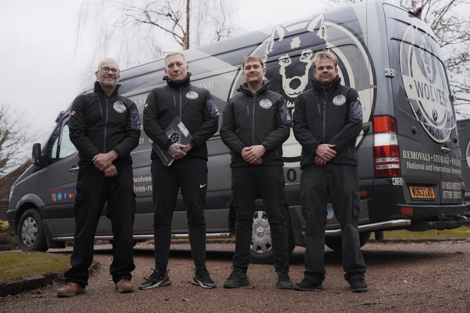 Wolves Removals crew team photo in front of vans