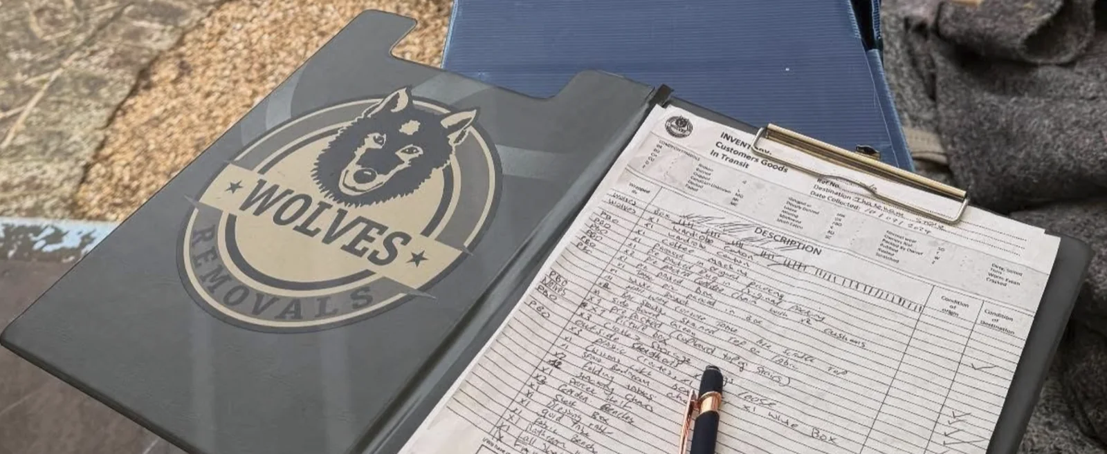 A Wolves Removals inventory clipboard and pen used during a free home survey and written quote