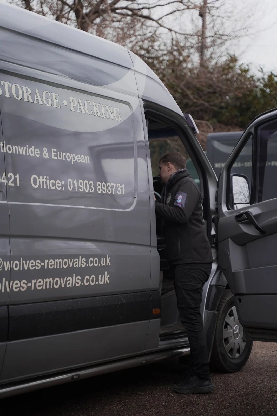 Crew member at the door of a Wolves van during a move in Crawley, West Sussex
