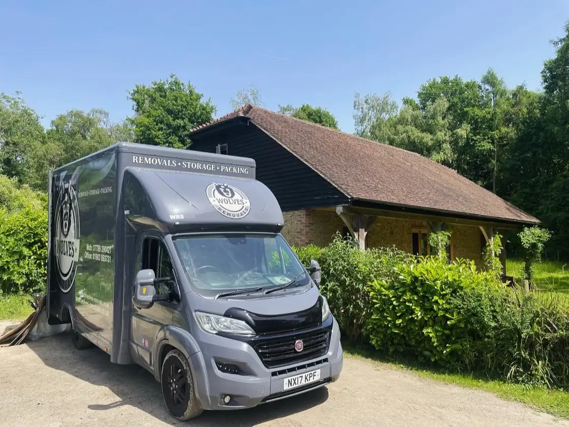 A Wolves Removals van parked outside a customer's home