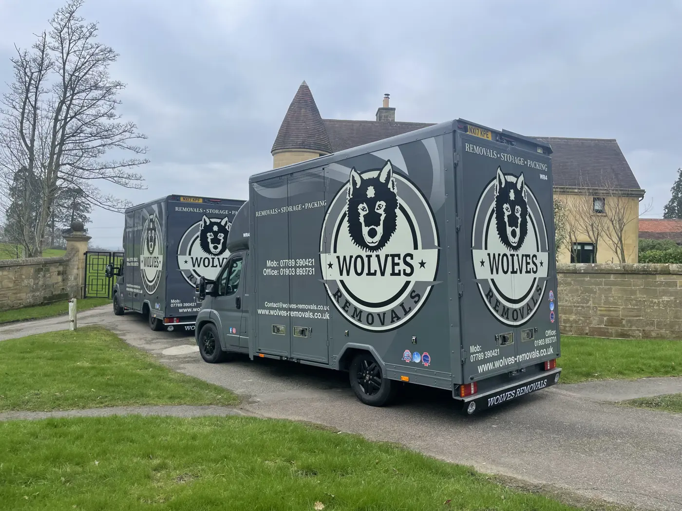 Two Wolves vans on a residential street