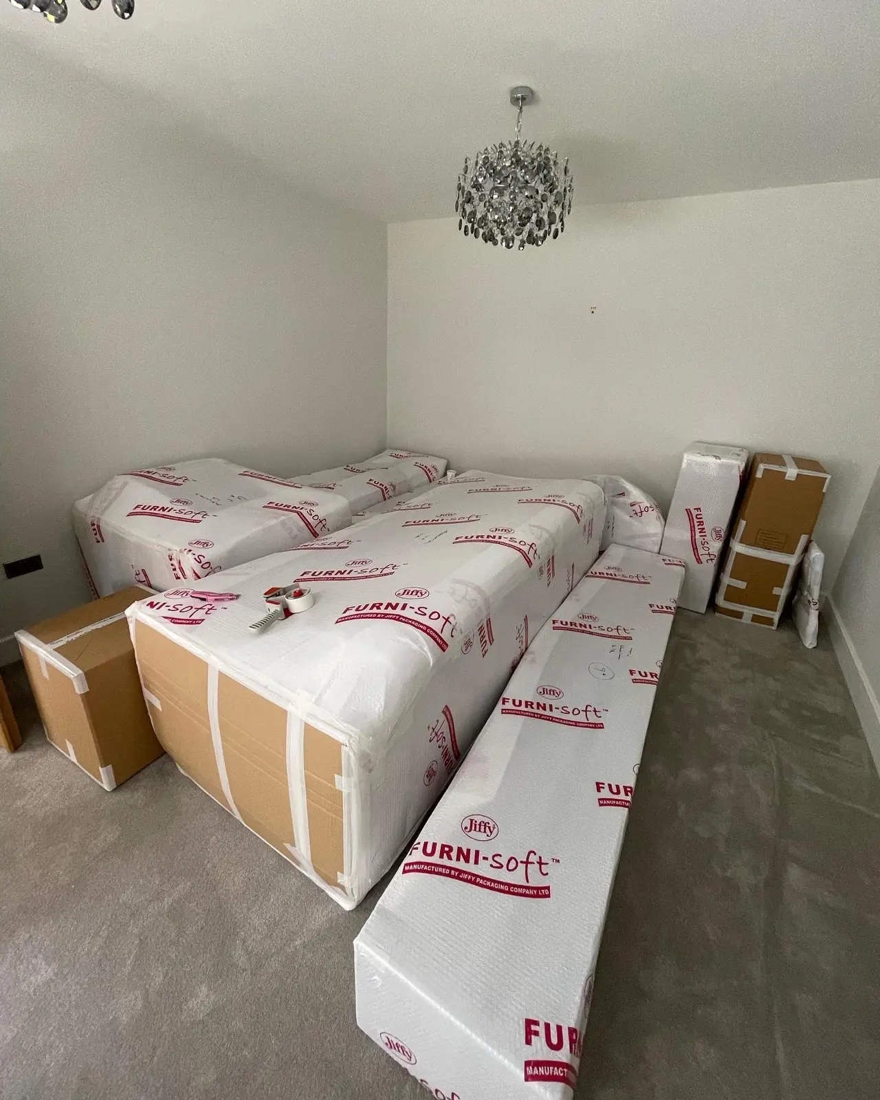 Wrapped mattresses and furniture, packed — a Brighton removal