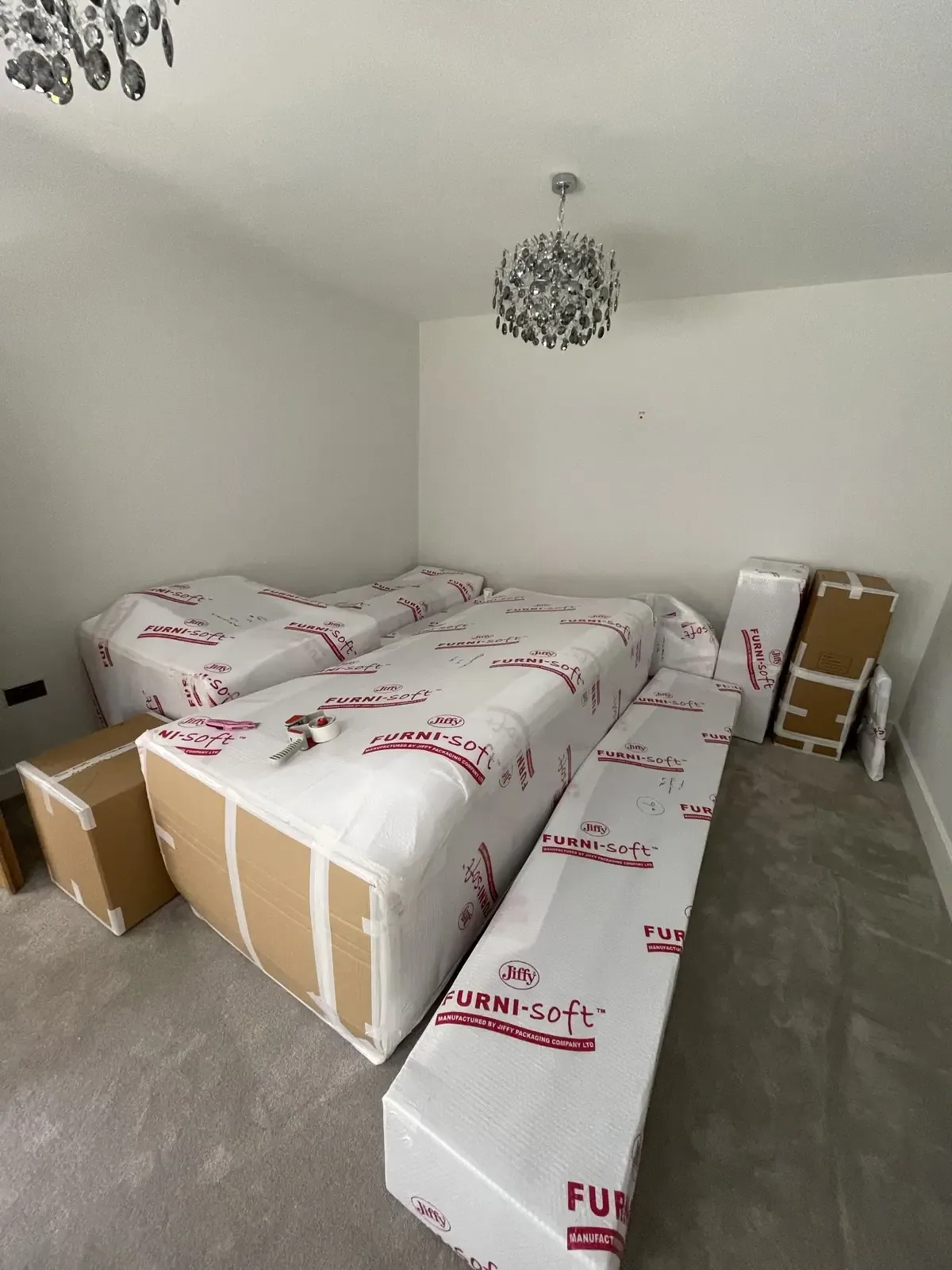 Wrapped mattresses and furniture in storage for a Hastings removal