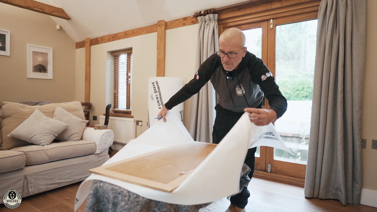 Wrapping an armchair in protective cover in the living room