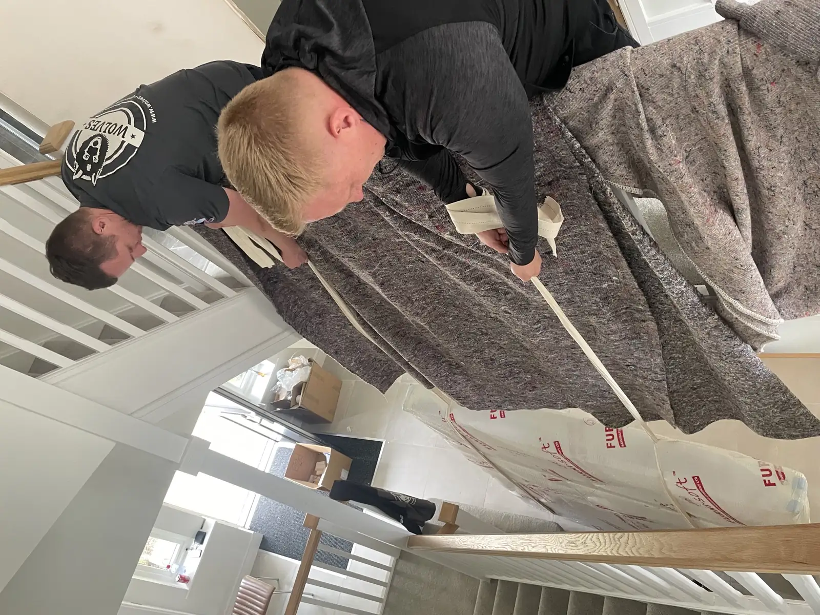 Wrapping large furniture in a protective cover, Surrey