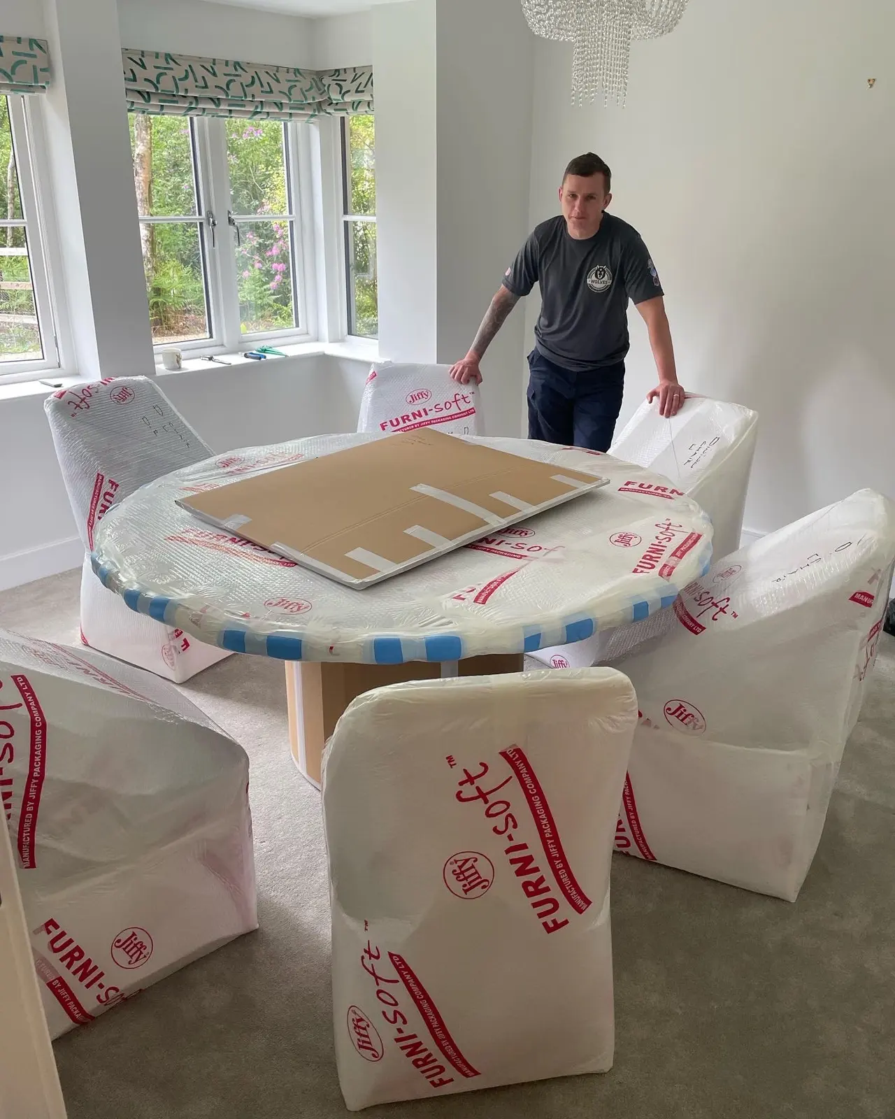 Wrapping a round table and chairs for a move in Guildford, Surrey